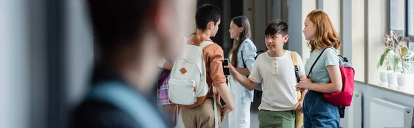 Ragazzo Sfocato Piedi Solo Vicino Agli Adolescenti Parlando Nel Corridoio — Foto Stock