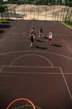 High angle view of multiethnic people playing basketball on playground outdoors  clipart