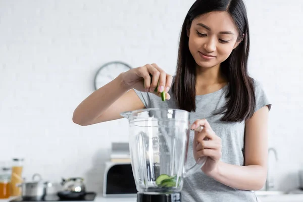 Smiling Asian Woman Adding Fresh Zucchini Electric Shaker Kitchen — Stock Photo, Image