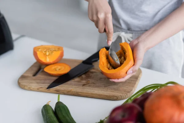 Cropped View Woman Cleaning Out Ripe Pumpkin Fresh Cucumbers Blurred — Stock Photo, Image