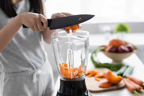 Cropped View Woman Cutting Pumpkin Electric Shaker Blurred Vegetables — Stock Photo, Image