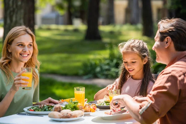 Smiling Woman Holding Orange Juice Family Food Outdoors — Stock Photo, Image