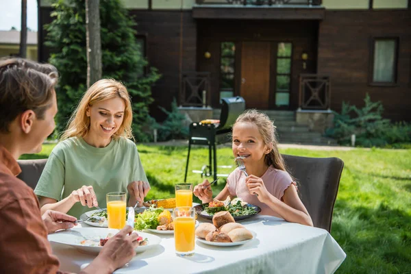 Smiling Kid Looking Camera While Eating Salad Parents Picnic — Stockfoto