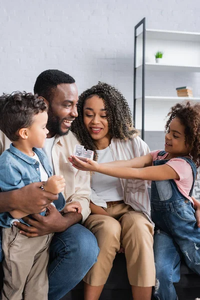 African American Girl Showing House Model Smiling Parents Brother — Stock Photo, Image