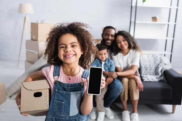 Cheerful African American Girl Cardboard Box Showing Smartphone Blank Screen — Stock Photo, Image