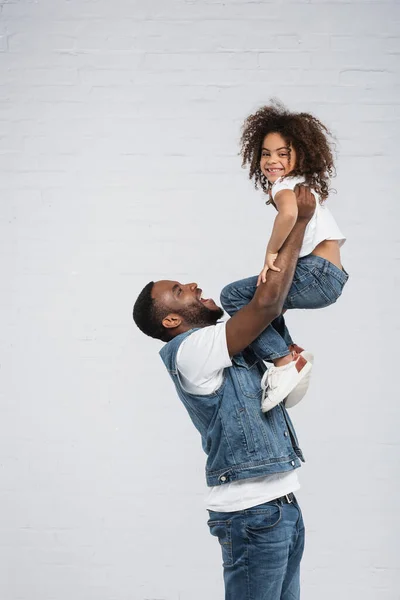 Joyful African American Man Raising Happy Child Grey — Stock Photo, Image