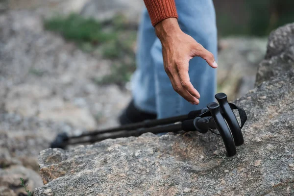 Cropped View Man Reaching Hiking Sticks Rock — Φωτογραφία Αρχείου