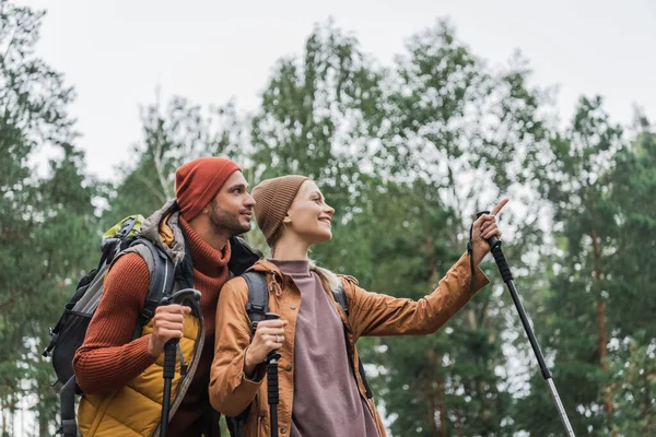 Happy Young Woman Pointing Away Finger Boyfriend Forest — Stockfoto