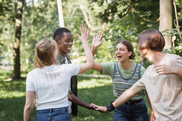 Cheerful Interracial Teen Friends Giving High Five Outdoors — Stock Photo, Image