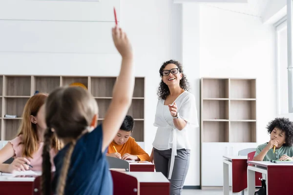 Back View Blurred Girl Raising Hand Smiling African American Teacher — Stock Photo, Image