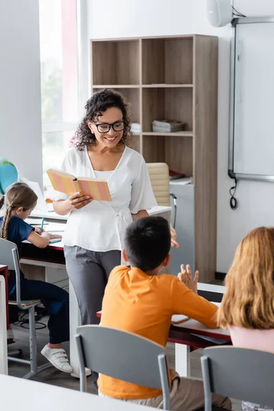 Smiling African American Teacher Holding Book Lesson Classroom — Stock Photo, Image