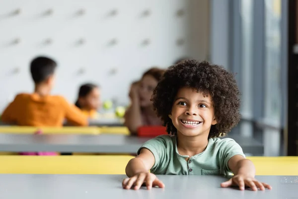 Cheerful African American Kid Sitting School Eatery Pupils Blurred Background — Stock Photo, Image