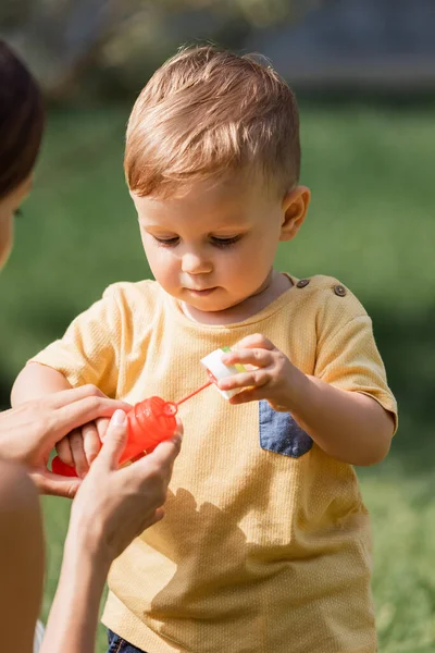 Blurred Mother Holding Bottle Bubble Wand Toddler Son — Stock Photo, Image