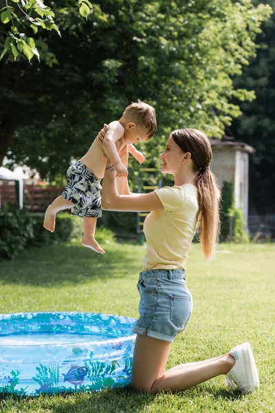 Side View Smiling Woman Holding Arms Toddler Son Inflatable Pool — Stock Photo, Image