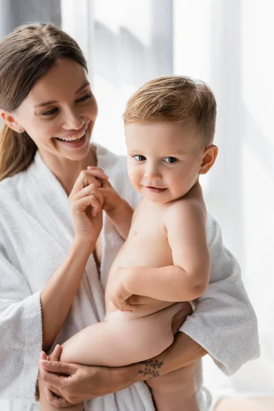 Joyful Tattooed Mother Bathrobe Holding Arms Nude Toddler Son — Stock Photo, Image