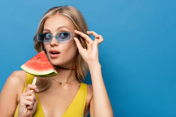 Young Woman Adjusting Sunglasses Holding Popsicle Stick Watermelon Isolated Blue — Stock Photo, Image