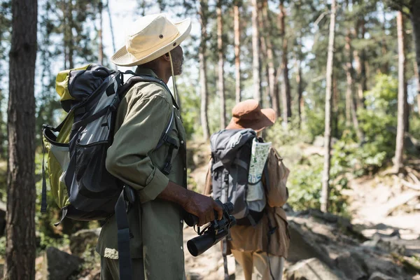 African American Hiker Backpack Binoculars Walking Blurred Wife Forest — Stock Photo, Image