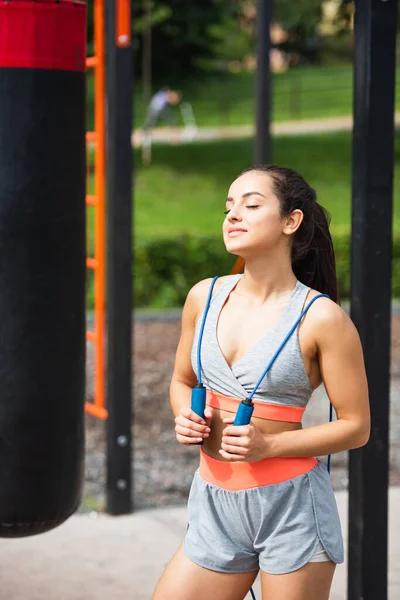 Pleased Sportswoman Closed Eyes Holding Jumping Rope — Stock Photo, Image