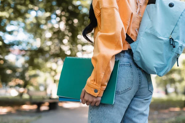 Cropped View Woman Jeans Orange Jacket Holding Notebooks Park — Stock Photo, Image