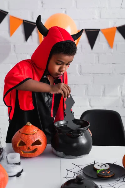 African American Boy Devil Halloween Costume Holding Paper Cut Bat — Stock Photo, Image
