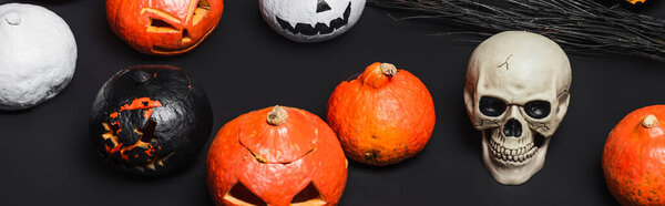 skull near broom and carved pumpkins on black, banner