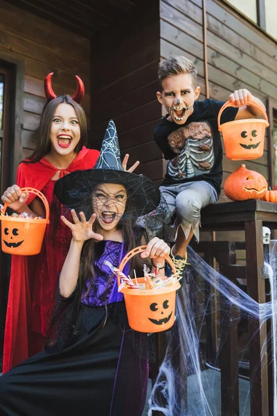 Children Halloween Costumes Holding Buckets Candies While Growling Showing Scary — Stock Photo, Image