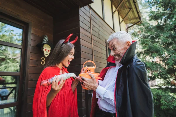 Excited Mature Man Vampire Halloween Costume Giving Bucket Sweets Amazed — Stock Photo, Image