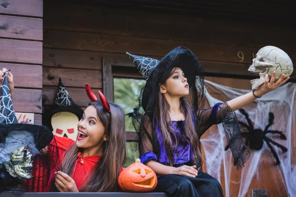 Girl Witch Hat Looking Skull Amazed Sister House Porch — Stock Photo, Image