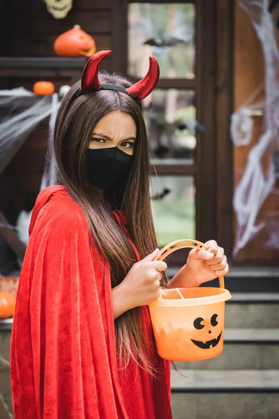 Angry Girl Devil Halloween Costume Black Medical Mask Holding Bucket — Stock Photo, Image