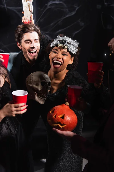 African American Woman Holding Carved Pumpkin Toy Hand While Laughing — Stock Photo, Image