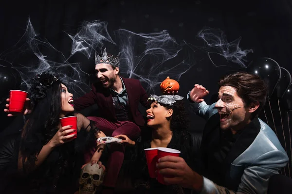 Excited Multiethnic Friends Plastic Cups Laughing Halloween Party Black — Stock Photo, Image