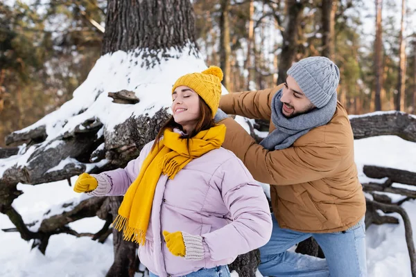 Homem Alegre Olhando Para Namorada Sorridente Perto Árvore Com Neve — Fotografia de Stock