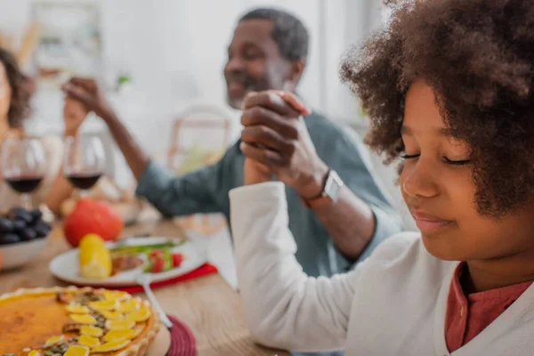 Selective Focus African American Girl Closed Eyes Praying Blurred Grandpa — Stock Photo, Image