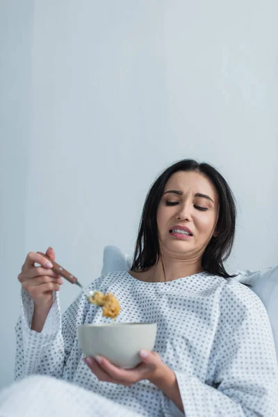 Disgusted Woman Holding Spoon Corn Flakes Bowl Hospital — Stock Photo, Image