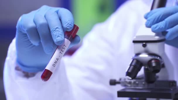 Cropped View Scientist Holding Test Tube Dna Test Microscope Royalty Free Stock Footage