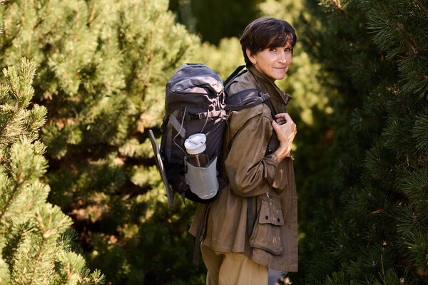 Active senior woman embark on an adventurous hike through beautiful mountainous terrain