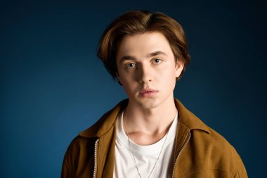 Yakışıklı genç adam havalı bir ifade ve moda kıyafetle tarzını sergiliyor..