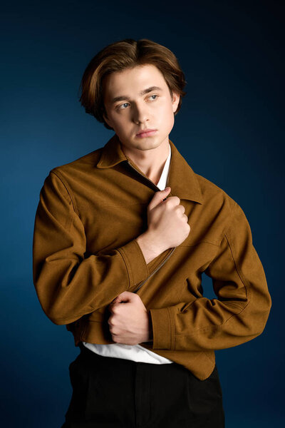 Young fashionable man showcases confidence with a stylish jacket in a captivating setting.