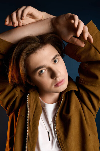 Handsome young man showcases trendy fashion while striking a unique pose, radiating charm.