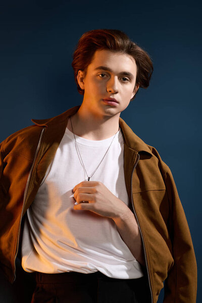 A fashionable young man stands elegantly, showcasing his unique style and charisma.