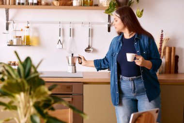 Waardenburg sendromlu bir kadın sıcak evinde kahve yapar..