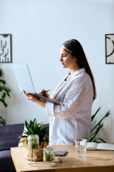 A woman with Waardenburg syndrome works from home, blending tasks and creativity peacefully.