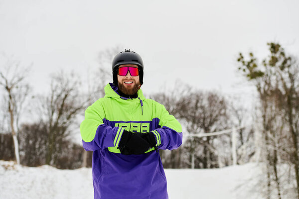 A bearded man gracefully snowboards down a snowy slope, showcasing his skills and style.