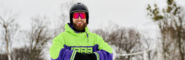 Snowboarder in vibrant outerwear rides down a snowy slope with a fun attitude and cool goggles, banner