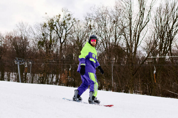 A bearded man confidently snowboards down a snowy slope, showcasing his skills in winter sports.