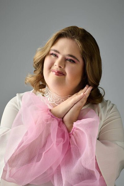 A cheerful young woman with Down syndrome smiles warmly, expressing happiness and creativity.