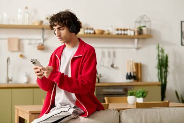 Yakışıklı, modaya uygun giyinmiş evde müzik dinlerken rahatlıyor..