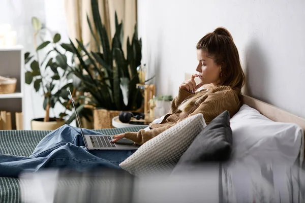 Genç bir kadın yatak odasında sakin bir gün geçirir. Yatakta uzanırken dizüstü bilgisayarıyla çalışır..