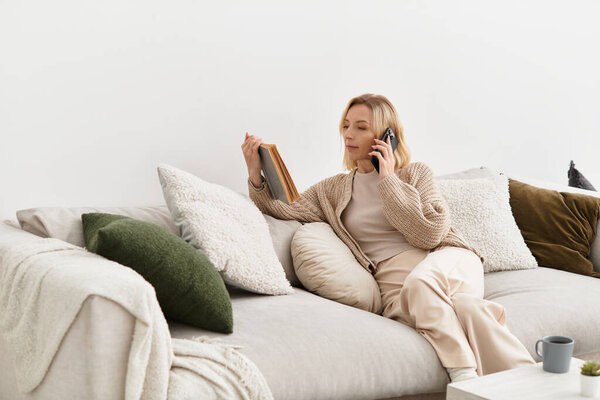 A blonde woman relaxes on a comfortable couch in her cozy apartment, chatting on the phone.