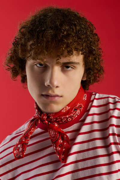 Young boy displays his fashion sense in trendy attire with an energetic pose and striking colors.